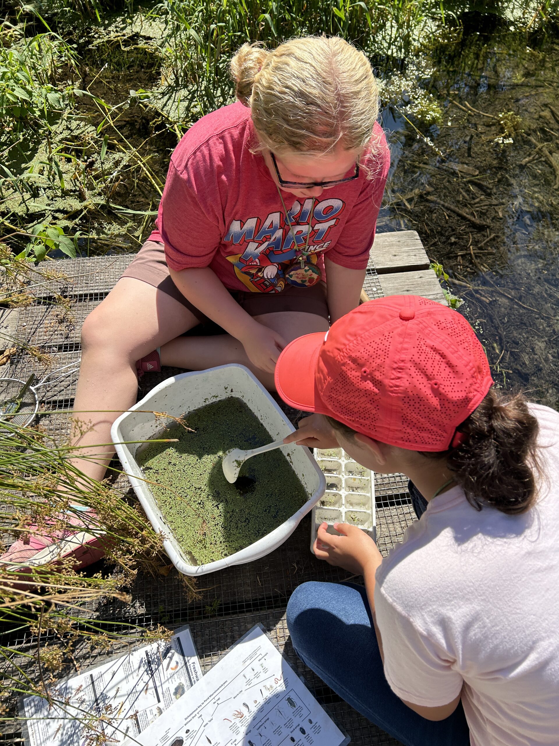 Kids wearing masks and playing with moss